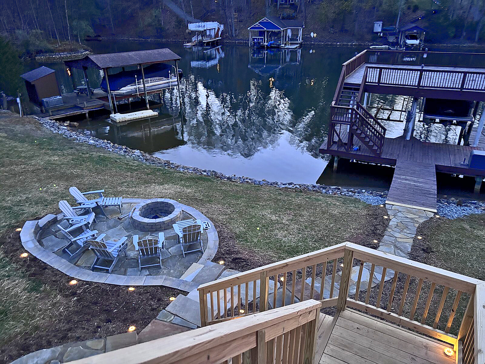 Private dock, fire-pit patio, and illuminated steps at Beaches Be Salty on Smith Mountain Lake