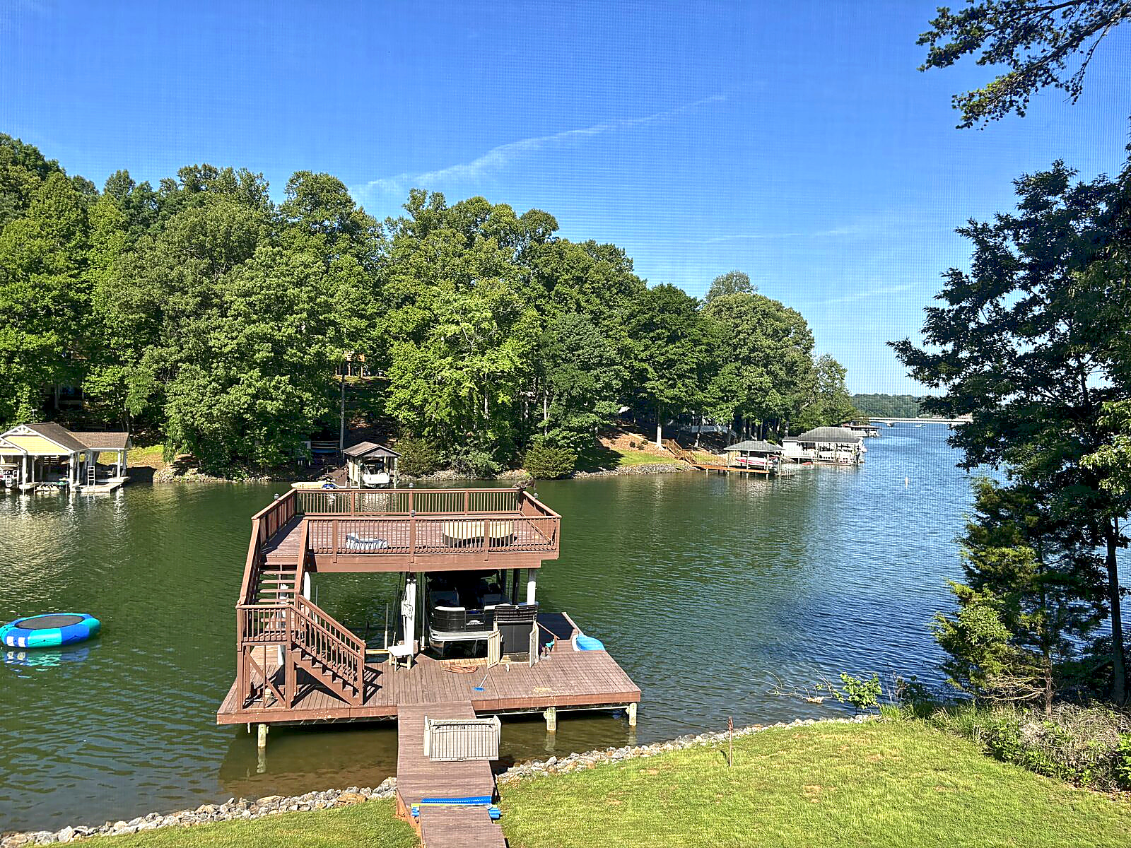 Private dock extending into a wooded cove at Beaches Be Salty on Smith Mountain Lake