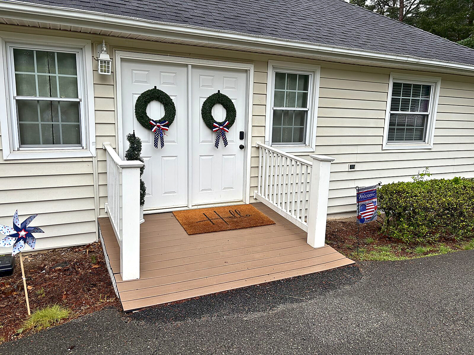 Front entrance of Beaches Be Salty with double doors, wreaths, and a small deck