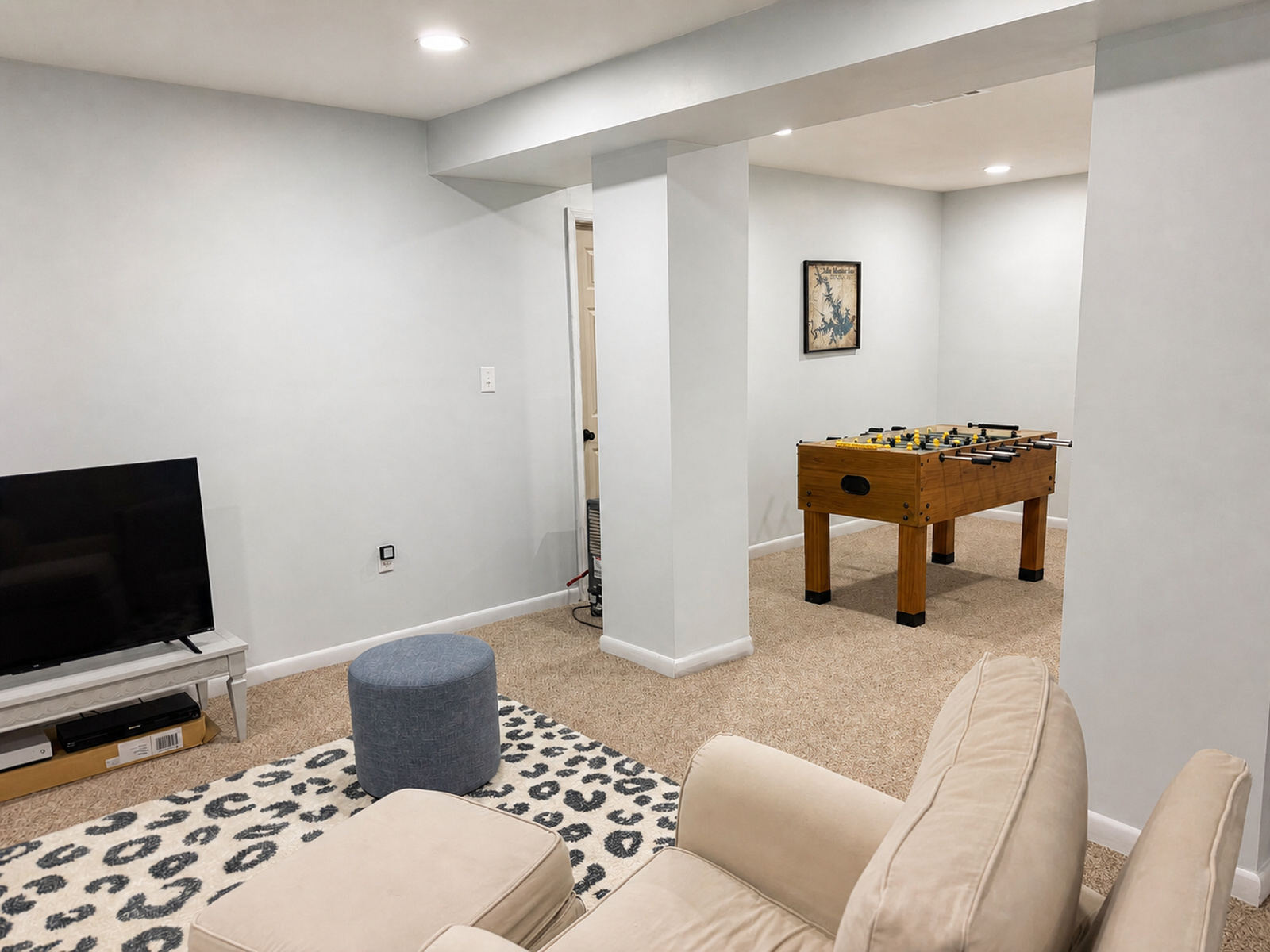 Lower-level recreation bonus room at Beaches Be Salty with foosball table and lounge seating