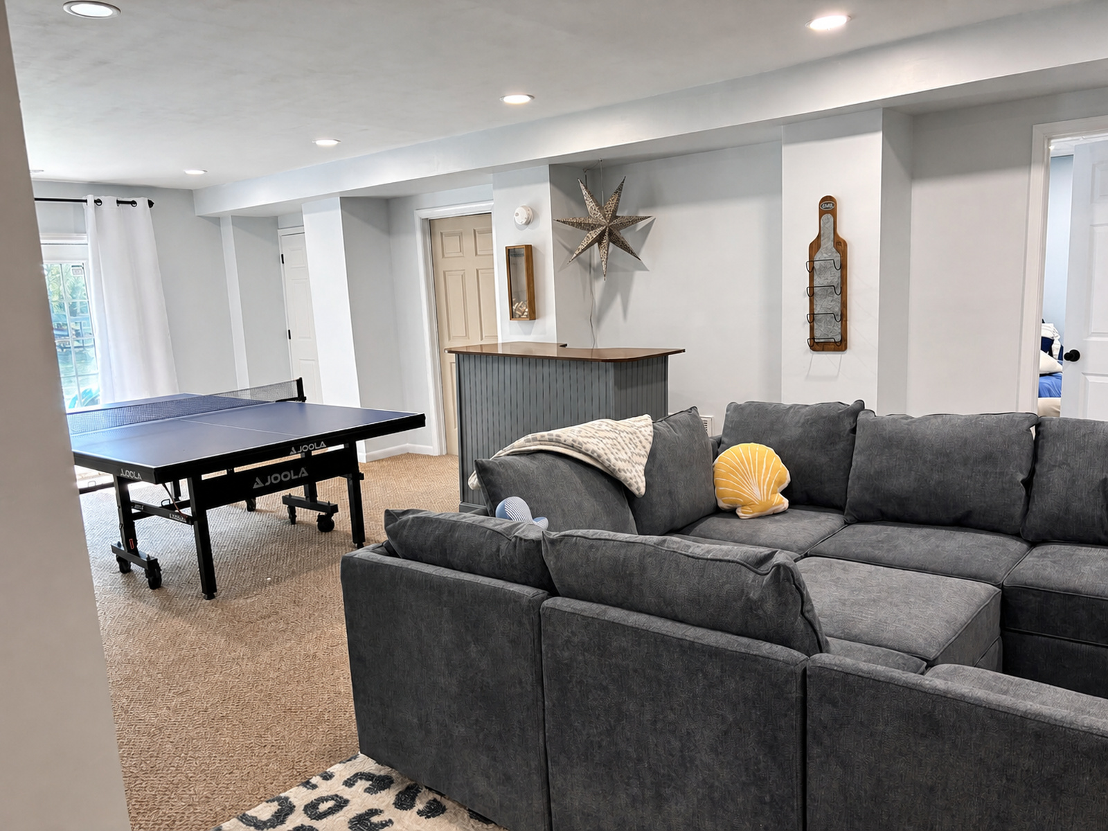 Lower-level recreation bonus room at Beaches Be Salty with sectional sofa, bar, and ping-pong table