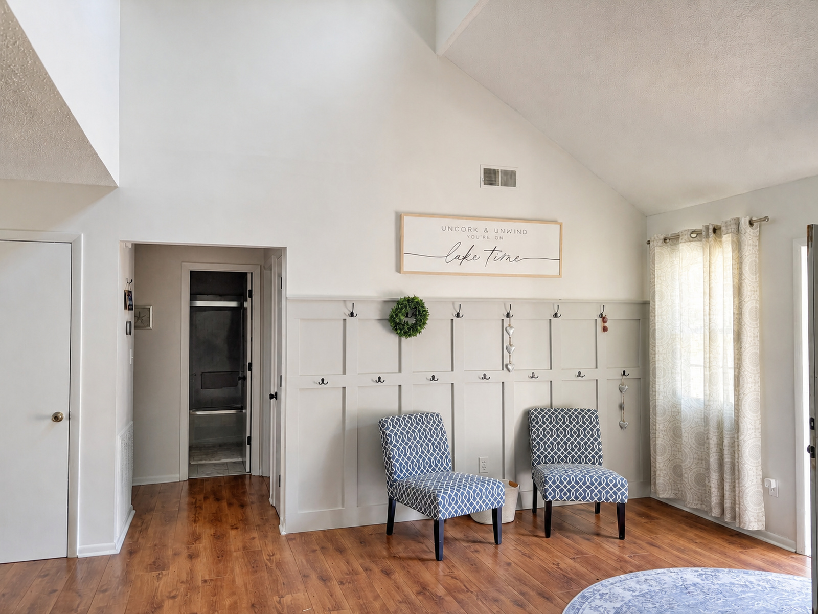 Open loft bonus room at Beaches Be Salty with two reading chairs beneath a vaulted ceiling